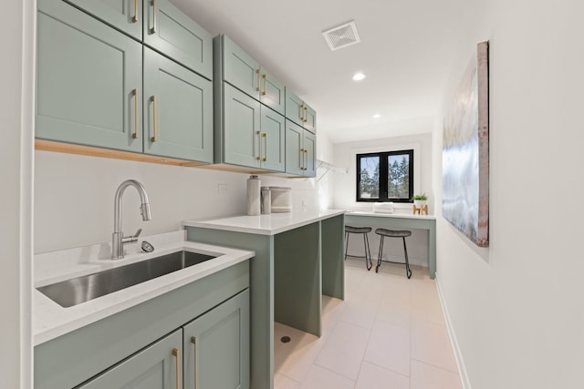 washroom with a sink, recessed lighting, light tile patterned flooring, and baseboards