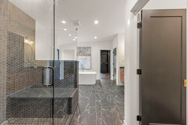 full bath featuring marble tiled floors, a soaking tub, a stall shower, and recessed lighting