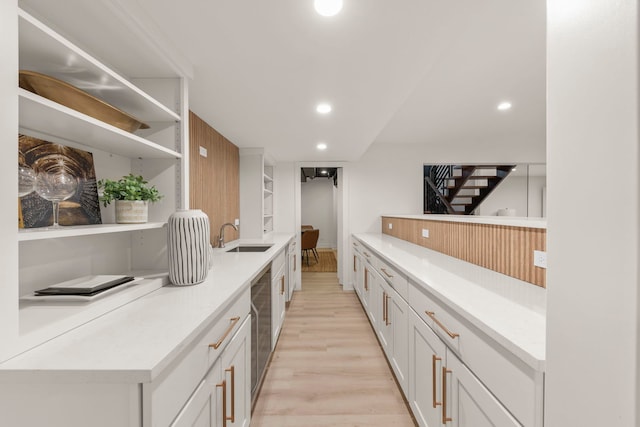 bar with a sink, light wood-type flooring, and recessed lighting