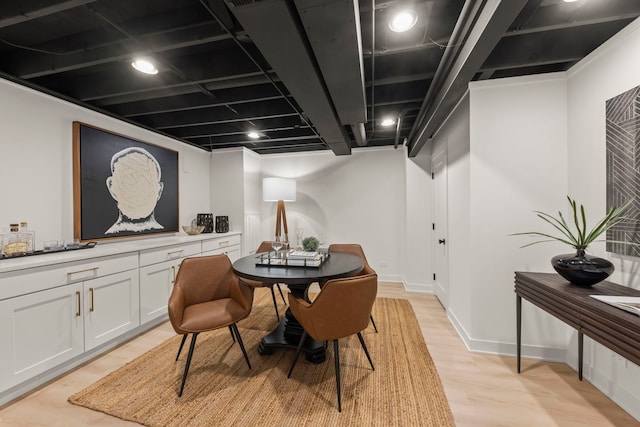 dining space with light wood-style floors and baseboards