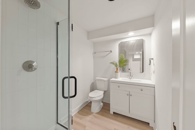 full bathroom with a shower stall, wood finished floors, toilet, vanity, and recessed lighting