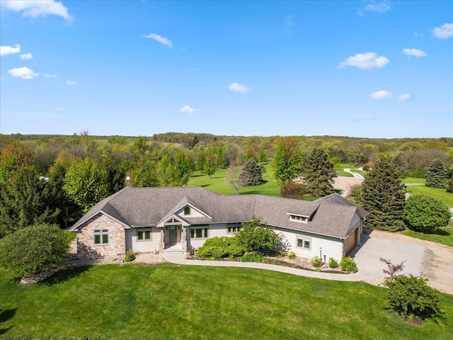 2297 Deer Ridge Ct, Carlock, IL 61725 - view of front of home featuring a front lawn, driveway, stone siding, and a forest view