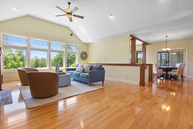 2297 Deer Ridge Ct, Carlock, IL 61725 - living area with light wood finished floors, a chandelier, ceiling fan, baseboards, and vaulted ceiling