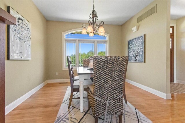 2297 Deer Ridge Ct, Carlock, IL 61725 - dining room with a chandelier, light wood finished floors, and baseboards