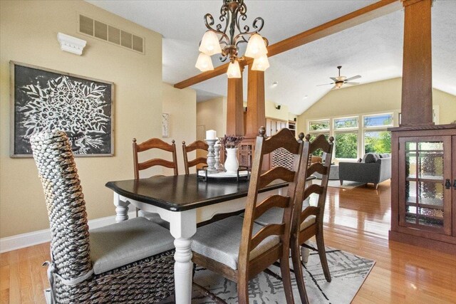 2297 Deer Ridge Ct, Carlock, IL 61725 - dining area with light wood-style floors, a ceiling fan, vaulted ceiling, baseboards, and a chandelier