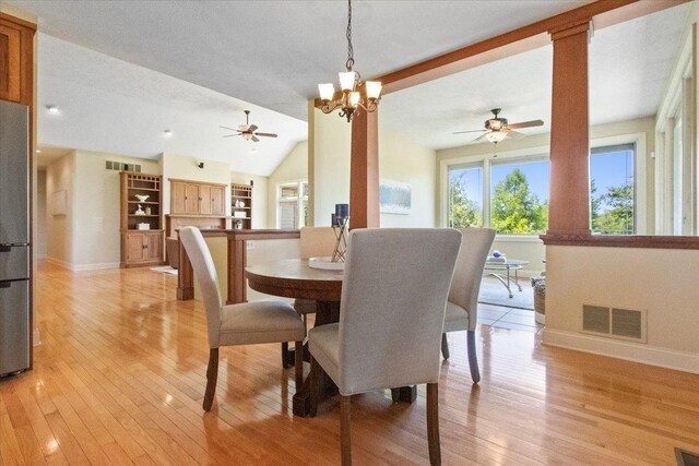 2297 Deer Ridge Ct, Carlock, IL 61725 - dining space with ceiling fan, baseboards, light wood finished floors, vaulted ceiling, and a chandelier