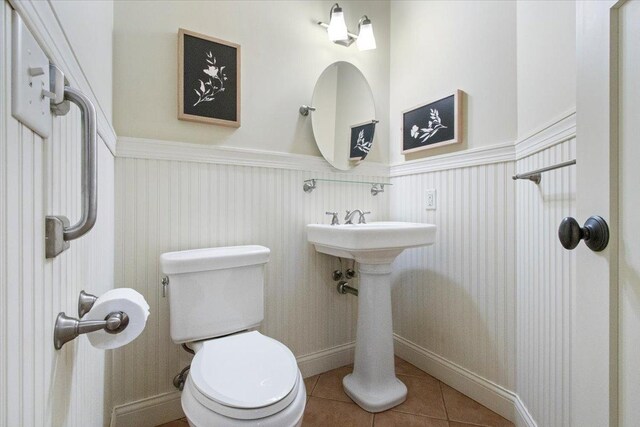 2297 Deer Ridge Ct, Carlock, IL 61725 - bathroom featuring wainscoting, tile patterned flooring, and toilet