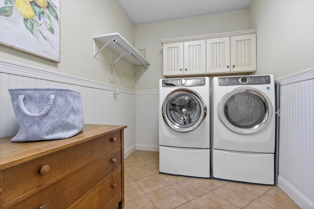 2297 Deer Ridge Ct, Carlock, IL 61725 - washroom with washer and clothes dryer, wainscoting, light tile patterned floors, and cabinet space