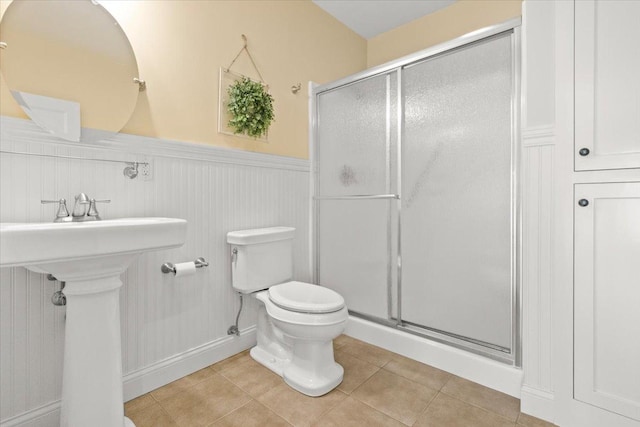 2297 Deer Ridge Ct, Carlock, IL 61725 - bathroom featuring wainscoting, toilet, a shower stall, tile patterned floors, and a sink