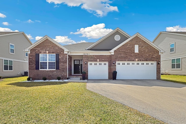 traditional-style home with asphalt driveway, brick siding, a garage, a front lawn, and central air condition unit