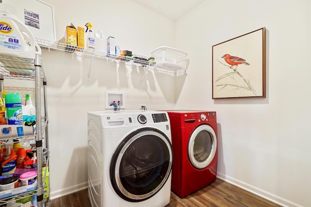 laundry area featuring wood finished floors, baseboards, and separate washer and dryer