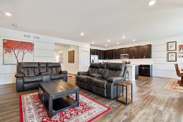 living room featuring wood finished floors and recessed lighting