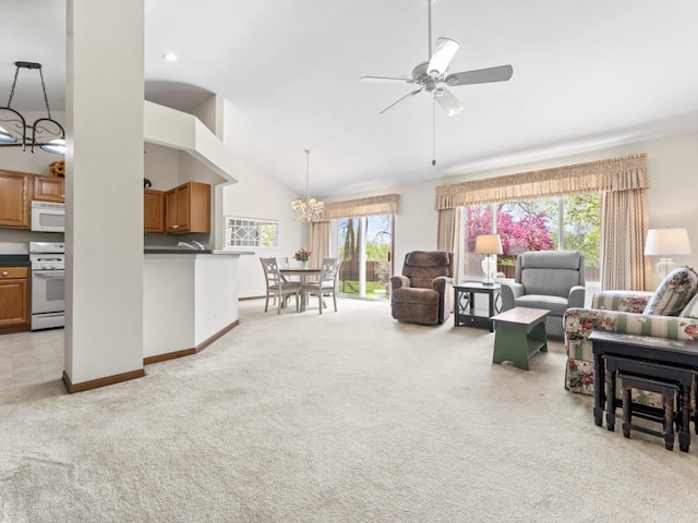 living room with light carpet, a chandelier, ceiling fan, lofted ceiling, and baseboards