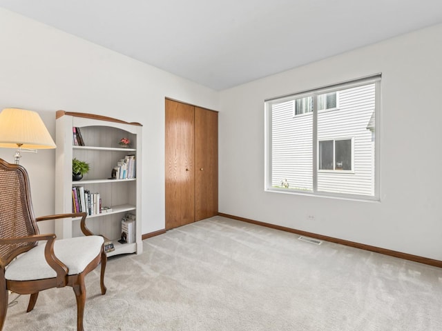 sitting room with light carpet and baseboards