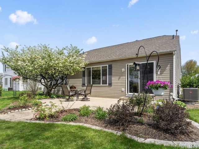 rear view of property featuring a patio and cooling unit