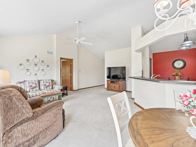living area with light colored carpet, lofted ceiling, a ceiling fan, and baseboards
