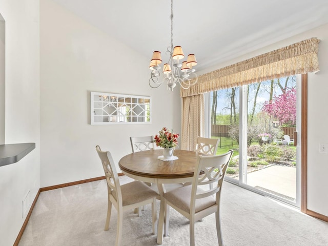 dining space with light colored carpet, a chandelier, and baseboards