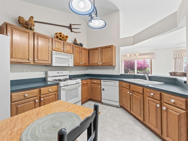 kitchen featuring white appliances, a sink, brown cabinets, high vaulted ceiling, and dark countertops