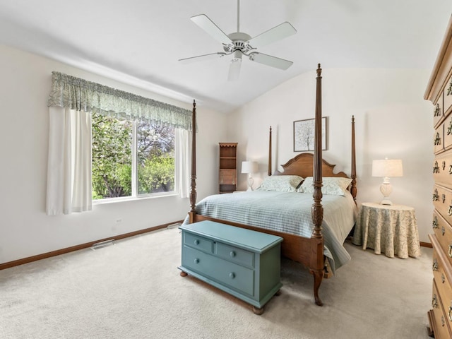 bedroom featuring light colored carpet, vaulted ceiling, baseboards, and ceiling fan