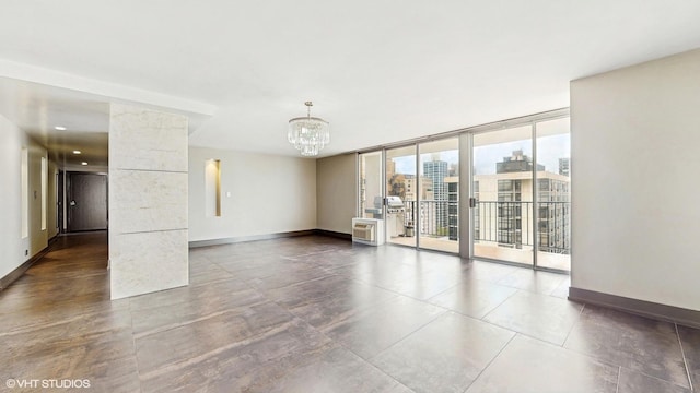 71 E Division St Unit 1801, Chicago, IL 60610 - empty room featuring a chandelier, baseboards, a wall of windows, and a view of city