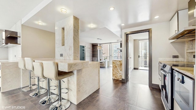 kitchen featuring white cabinetry, a breakfast bar, modern cabinets, and recessed lighting
