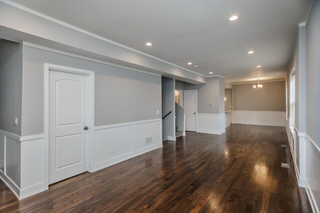 7605 S Champlain Ave, Chicago, IL 60619 - below grade area with a wainscoted wall, dark wood-style flooring, stairs, recessed lighting, and crown molding