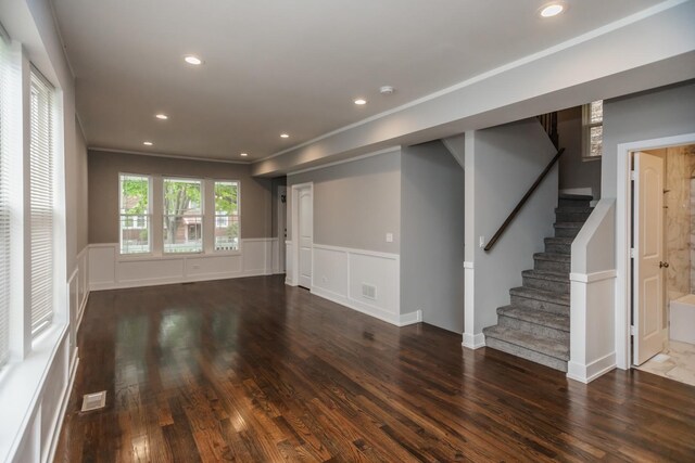 7605 S Champlain Ave, Chicago, IL 60619 - unfurnished living room featuring wood finished floors, wainscoting, stairway, and recessed lighting
