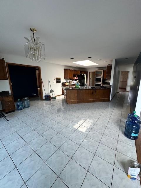 8005 W 143rd Pl, Orland Park, IL 60462 - living room featuring light tile patterned floors and a chandelier