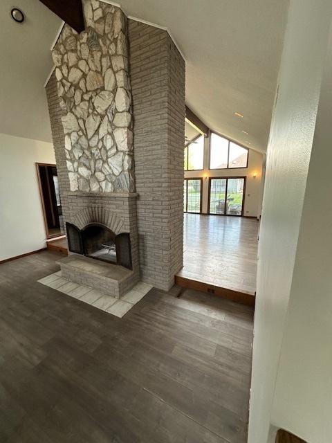 8005 W 143rd Pl, Orland Park, IL 60462 - unfurnished living room featuring a fireplace, high vaulted ceiling, wood finished floors, beamed ceiling, and baseboards