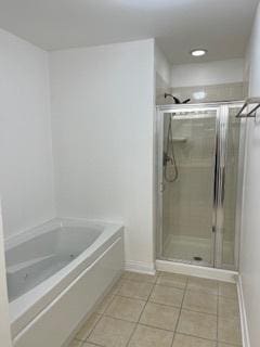 full bath featuring tile patterned floors, a bath, a shower stall, baseboards, and recessed lighting