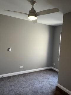 empty room with baseboards and dark carpet