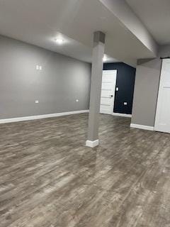 finished basement featuring baseboards and wood finished floors