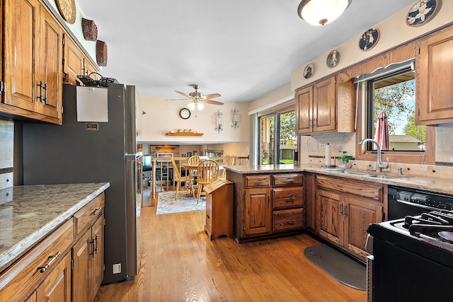 8120 Cherokee Trl, Tinley Park, IL 60477 - kitchen with a sink, freestanding refrigerator, a peninsula, and brown cabinetry