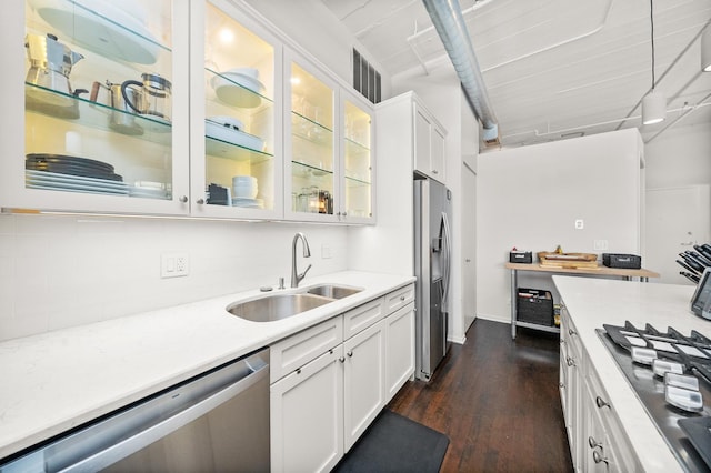 kitchen with stainless steel appliances, a sink, light countertops, and white cabinetry