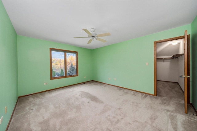 631 Indian Trail Dr, Palos Park, IL 60464 - unfurnished bedroom with a spacious closet, carpet flooring, baseboards, and a ceiling fan