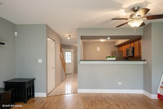 1788 Nature Ct, Schaumburg, IL 60193 - kitchen with stainless steel appliances, brown cabinets, a ceiling fan, dark countertops, and baseboards