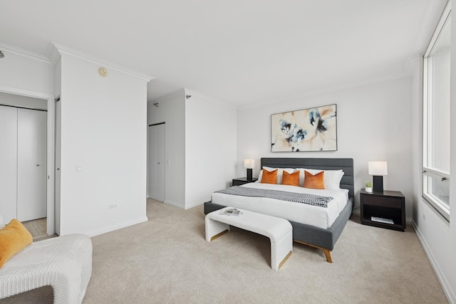 bedroom featuring light colored carpet, crown molding, and baseboards