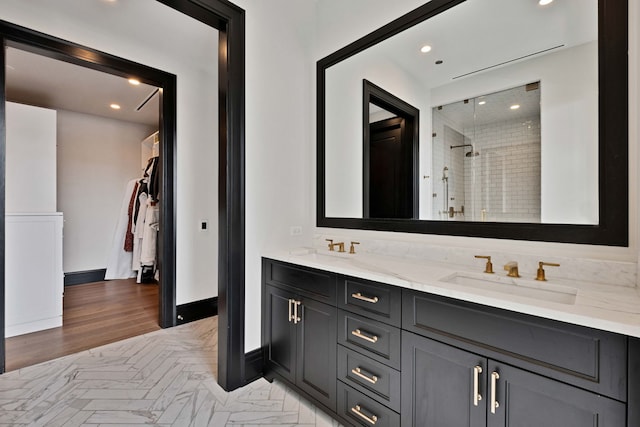 1109 W Washington Blvd Unit 5C, Chicago, IL 60607 - bathroom featuring a stall shower, recessed lighting, a spacious closet, double vanity, and wood finished floors