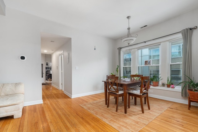 908 W Lakeside Pl Unit 3W, Chicago, IL 60640 - dining space featuring light wood-type flooring, baseboards, and healthy amount of natural light