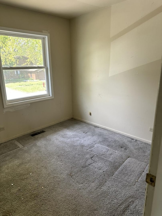 carpeted empty room with baseboards