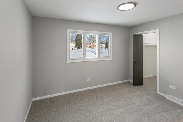 22751 Redwood Dr, Richton Park, IL 60471 - unfurnished bedroom featuring carpet, baseboards, a closet, and a walk in closet