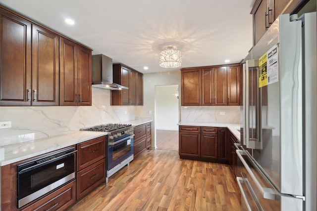 6709 W Menominee Pkwy, Palos Heights, IL 60463 - kitchen with appliances with stainless steel finishes, wall chimney range hood, light wood-type flooring, recessed lighting, and decorative backsplash