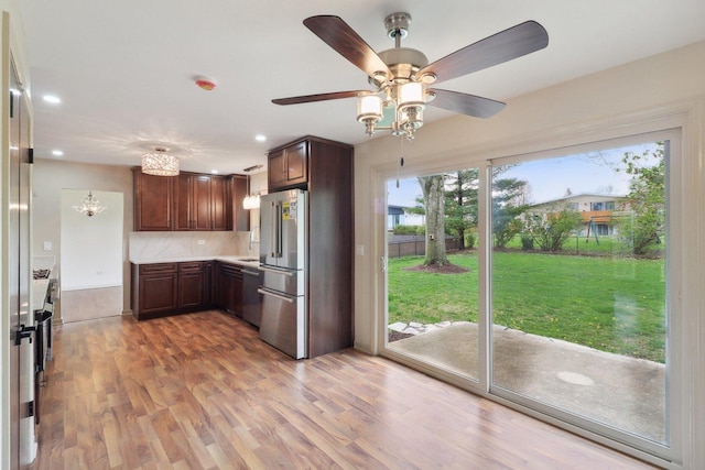 6709 W Menominee Pkwy, Palos Heights, IL 60463 - kitchen with appliances with stainless steel finishes, light countertops, tasteful backsplash, light wood-style flooring, and recessed lighting