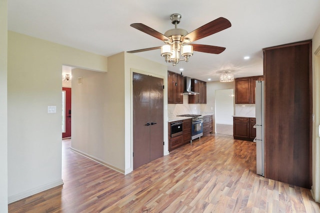6709 W Menominee Pkwy, Palos Heights, IL 60463 - kitchen with wall chimney exhaust hood, light countertops, backsplash, ceiling fan, and light wood-style flooring