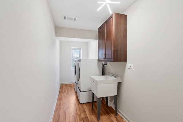 6709 W Menominee Pkwy, Palos Heights, IL 60463 - laundry room featuring cabinet space, washer and clothes dryer, light wood-style floors, and baseboards