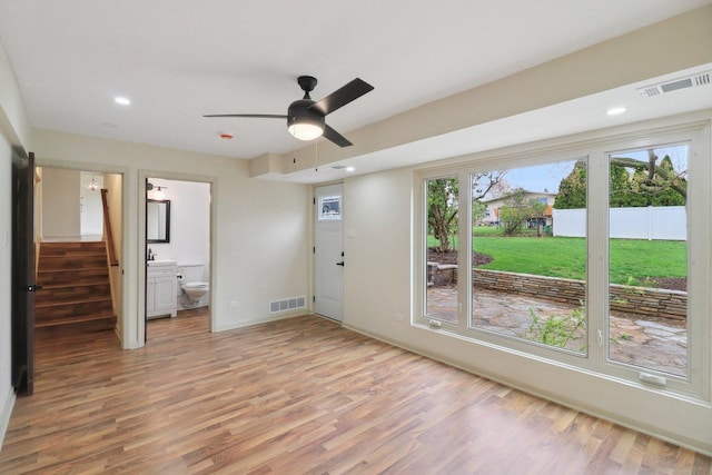 6709 W Menominee Pkwy, Palos Heights, IL 60463 - empty room with light wood-style flooring, stairs, a ceiling fan, recessed lighting, and baseboards