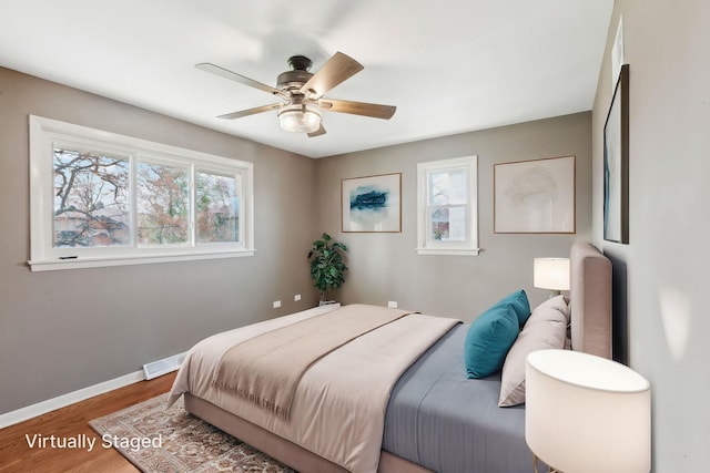 6709 W Menominee Pkwy, Palos Heights, IL 60463 - bedroom featuring multiple windows, wood finished floors, baseboards, and a ceiling fan