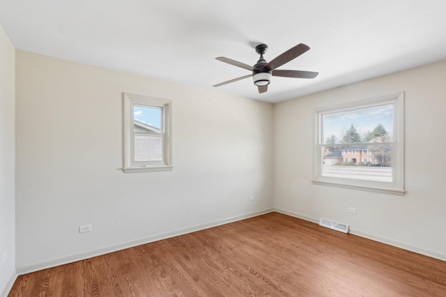 6709 W Menominee Pkwy, Palos Heights, IL 60463 - spare room featuring wood finished floors, baseboards, and a ceiling fan