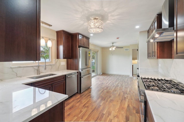 6709 W Menominee Pkwy, Palos Heights, IL 60463 - kitchen with a sink, stainless steel appliances, wall chimney exhaust hood, light wood finished floors, and a ceiling fan