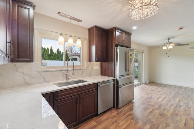 6709 W Menominee Pkwy, Palos Heights, IL 60463 - kitchen with appliances with stainless steel finishes, a sink, backsplash, and plenty of natural light